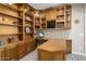 Spacious home office with extensive built-in cabinetry and a large desk at 3507 N Snead Dr, Goodyear, AZ 85395