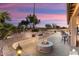 Covered patio features a fire pit and outdoor seating area at 3507 N Snead Dr, Goodyear, AZ 85395