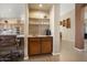 Built-in wet bar with granite countertop and wooden cabinets at 3507 N Snead Dr, Goodyear, AZ 85395