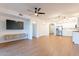 Open living room with wood floors, kitchen and bedroom access at 920 E Devonshire Ave # 2019, Phoenix, AZ 85014