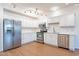 Modern kitchen with white cabinets, stainless steel appliances, and wood floors at 920 E Devonshire Ave # 2019, Phoenix, AZ 85014