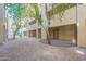 Ground level view of a serene courtyard with trees and gravel at 920 E Devonshire Ave # 2019, Phoenix, AZ 85014