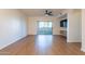 Bright living room with wood-look floors, sliding glass door to patio, and ceiling fan at 920 E Devonshire Ave # 2019, Phoenix, AZ 85014