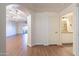 Bright hallway with wood floors, archway, and access to living area and bathroom at 920 E Devonshire Ave # 2019, Phoenix, AZ 85014