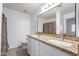 Double vanity bathroom with granite countertop and large mirror at 920 E Devonshire Ave # 2019, Phoenix, AZ 85014