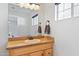 Bathroom with light wood vanity, granite countertop and a large mirror at 1506 E Oregon Ave, Phoenix, AZ 85014