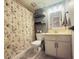 Full bathroom with floral shower curtain, vanity, and toilet at 6943 W Virginia Ave, Phoenix, AZ 85035