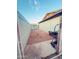 Gravel backyard with block wall and gate at 6943 W Virginia Ave, Phoenix, AZ 85035