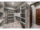 Large walk-in closet with ample shelving and hanging space at 32614 N 227Th Ave, Wittmann, AZ 85361