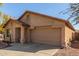 Tan house with a two-car garage and landscaping at 16019 W Moreland St, Goodyear, AZ 85338