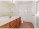 Bathroom with wood vanity, tile floor and shower at 16019 W Moreland St, Goodyear, AZ 85338