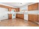 View of kitchen with wood cabinets and appliances at 16019 W Moreland St, Goodyear, AZ 85338