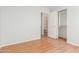 Bedroom with wood flooring, access to bathroom and closet at 16019 W Moreland St, Goodyear, AZ 85338