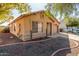 Tan house with a two-car garage and landscaping at 16019 W Moreland St, Goodyear, AZ 85338
