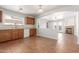 Kitchen features wood cabinets and a view into the living room at 16019 W Moreland St, Goodyear, AZ 85338