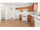 Kitchen with wood cabinets, tile floor, and appliances at 16019 W Moreland St, Goodyear, AZ 85338