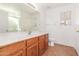 Bathroom with wood vanity and tile flooring at 16019 W Moreland St, Goodyear, AZ 85338