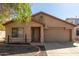 Tan house with a two-car garage and landscaping at 16019 W Moreland St, Goodyear, AZ 85338