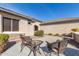 Front patio with wicker chairs and a glass top table at 26984 W Yukon Dr, Buckeye, AZ 85396