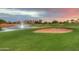 Golf course with sand trap and pond, beautiful sunset in the background at 2640 E Golden Trl, Casa Grande, AZ 85194