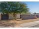Modern home with a sleek metal facade and a low brick wall in the front yard at 3033 E Sierra St, Phoenix, AZ 85028