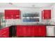 Kitchen with red cabinets, granite countertops, and a stainless steel sink at 3033 E Sierra St, Phoenix, AZ 85028