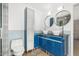 Bathroom with blue vanity, large mirror, and modern fixtures at 3033 E Sierra St, Phoenix, AZ 85028