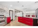 Modern kitchen with red cabinets, island, and stainless steel appliances at 3033 E Sierra St, Phoenix, AZ 85028