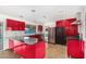 Sleek kitchen featuring red cabinets, granite countertops, and stainless steel appliances at 3033 E Sierra St, Phoenix, AZ 85028
