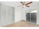 Bright bedroom with sliding door, ceiling fan, and built-in closet at 3033 E Sierra St, Phoenix, AZ 85028