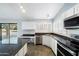 Kitchen with granite island, white cabinets and pool access at 19537 N 69Th Ave, Glendale, AZ 85308