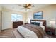 Bedroom with queen bed, ceiling fan, and window at 5138 W Fulton St, Phoenix, AZ 85043