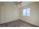 Simple bedroom with neutral carpeting and a ceiling fan at 5138 W Fulton St, Phoenix, AZ 85043