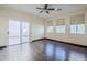Bedroom with hardwood floors and sliding glass door to patio at 5138 W Fulton St, Phoenix, AZ 85043