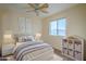 Charming bedroom with a queen bed, window, ceiling fan, and storage at 5138 W Fulton St, Phoenix, AZ 85043