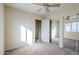 Well-lit bedroom with mirrored closet doors and ceiling fan at 5138 W Fulton St, Phoenix, AZ 85043