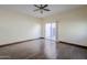 Simple bedroom with hardwood floors and sliding glass door to patio at 5138 W Fulton St, Phoenix, AZ 85043