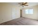 Simple bedroom with neutral carpeting and ceiling fan at 5138 W Fulton St, Phoenix, AZ 85043