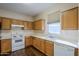 Kitchen with wood cabinets and stainless steel appliances at 5138 W Fulton St, Phoenix, AZ 85043