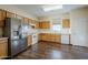 Kitchen with wood cabinets, stainless steel appliances, and hardwood floors at 5138 W Fulton St, Phoenix, AZ 85043