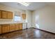Kitchen with wood cabinets, stainless steel appliances, and hardwood floors at 5138 W Fulton St, Phoenix, AZ 85043