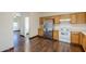 Kitchen with wood cabinets, stainless steel appliances, and hardwood floors at 5138 W Fulton St, Phoenix, AZ 85043