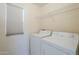 Laundry room with washer, dryer, and shelving at 5138 W Fulton St, Phoenix, AZ 85043