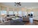 Living room with hardwood floors, neutral decor, and adjacent dining area at 5138 W Fulton St, Phoenix, AZ 85043