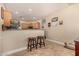 Kitchen breakfast bar with two wooden stools, great for casual dining at 6613 S 16Th Dr, Phoenix, AZ 85041