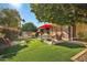 Relaxing backyard oasis with patio furniture, putting green, and lush landscaping at 18903 N 97Th Ln, Peoria, AZ 85382