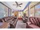 Cozy sunroom furnished with comfortable leather seating at 18903 N 97Th Ln, Peoria, AZ 85382