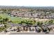 Aerial view showcasing a golf course, lake, and residential neighborhood at 18903 N 97Th Ln, Peoria, AZ 85382