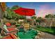 Outdoor patio with seating area and red umbrella at 18903 N 97Th Ln, Peoria, AZ 85382