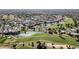 Aerial view of community near golf course with pond and clubhouse at 18903 N 97Th Ln, Peoria, AZ 85382
